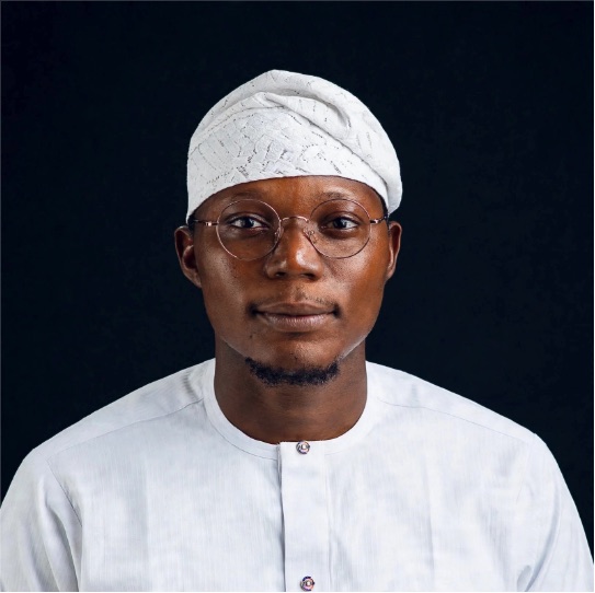 Portrait of Kayode Hamzat in a white cap